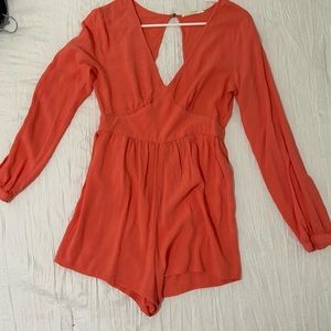Orange, romper slight opening at the front and back long sleeve with  Zip back